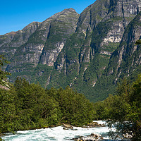 Buy canvas prints of River through the mountains near Briksdals Glacier by Andrew Michael