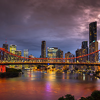 Buy canvas prints of Story Bridge lit up after dark with Brisbane city  by Andrew Michael