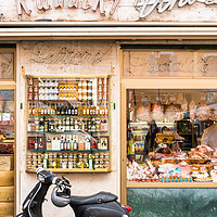 Buy canvas prints of Vespa scooter outside traditional Grocery store by Andrew Michael