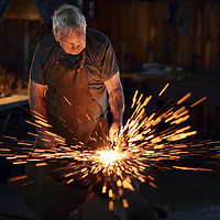 Buy canvas prints of Blacksmith hammering red hot iron by Johan Swanepoel