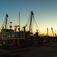 Buy canvas prints of Silhouette of fishing boats by Clive Wells
