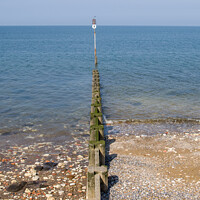 Buy canvas prints of Groyne sea defence going out to sea by Clive Wells