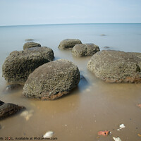 Buy canvas prints of Boulders on smooth sea by Clive Wells
