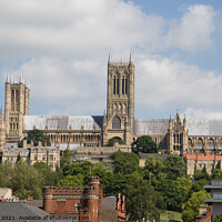 Buy canvas prints of Lincoln Cathedral over the roof tops by Clive Wells