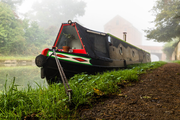 Moored narrow boat in the mist. Picture Board by Clive Wells