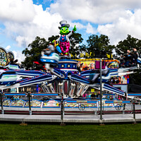 Buy canvas prints of Speedy fairground ride in the WALKS, Kings Lynn. by Clive Wells