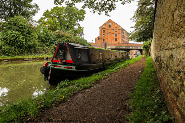 Lone narrowboat moored near the bridge Picture Board by Clive Wells