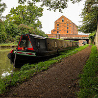 Buy canvas prints of Lone narrowboat moored near the bridge by Clive Wells