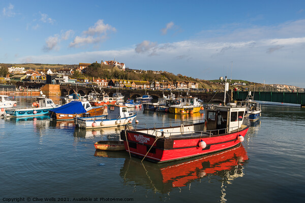 Fishing boats at high tide Picture Board by Clive Wells