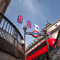 Buy canvas prints of Bunting above the tube station with London bus. by Clive Wells