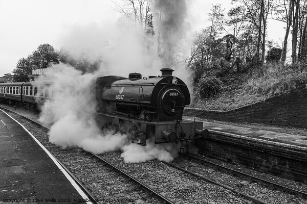 Stean train now leaving Llangollen Station in monochrome Picture Board by Clive Wells