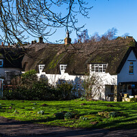 Buy canvas prints of Whitewashed thatched cottage by Clive Wells