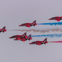 Buy canvas prints of Red Arrows with coloured smoke on at Duxford by Clive Wells