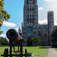Buy canvas prints of Cannon andCathedral seen in Ely, Cambridgeshire  by Clive Wells
