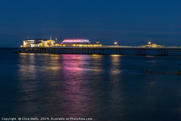 Cromer Pier at night in North Norfolk Picture Board by Clive Wells