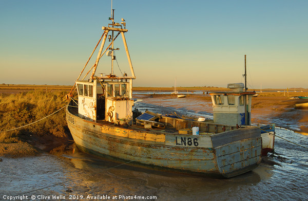 Fishing boat grounded at Brancaster Staith Picture Board by Clive Wells