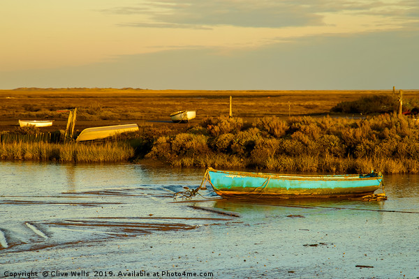 Row boat at Brancaster Staith in North Norfolk Picture Board by Clive Wells