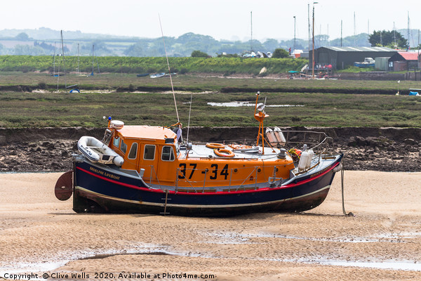 Lifeboat sitting on the mud flaps at Wells-Next-Se Picture Board by Clive Wells