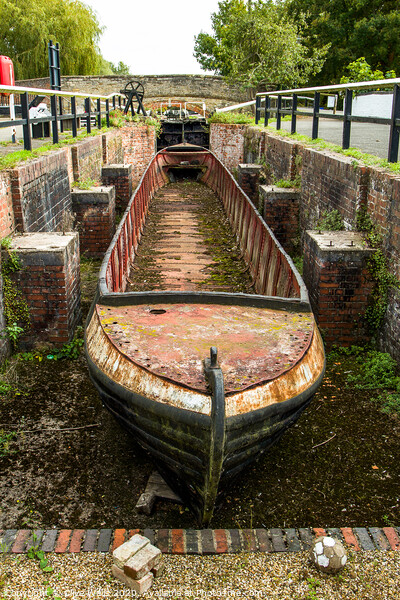 Abandoned shell of narrowboat at Stoke Brurne in N Picture Board by Clive Wells