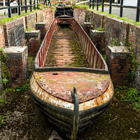 Buy canvas prints of Abandoned shell of narrowboat at Stoke Brurne in N by Clive Wells