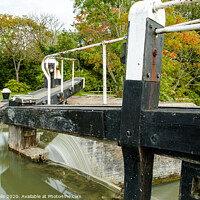 Buy canvas prints of Overflowing lock gates. by Clive Wells
