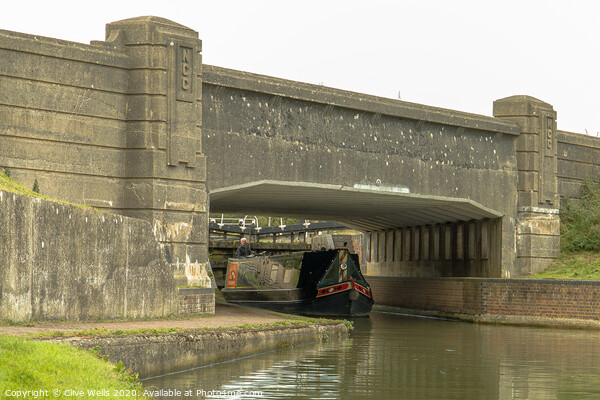 Canal boat under the bridge Picture Board by Clive Wells