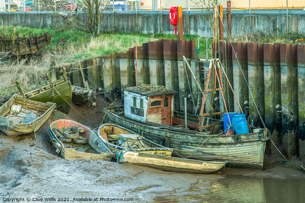 Abandoned boats at low tide Picture Board by Clive Wells