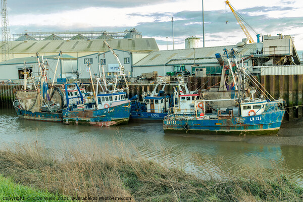 Line up of fishing boats Picture Board by Clive Wells