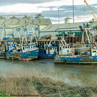 Buy canvas prints of Line up of fishing boats by Clive Wells