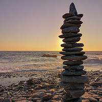 Buy canvas prints of Stacked stones before a sunset  by Susan Ireland
