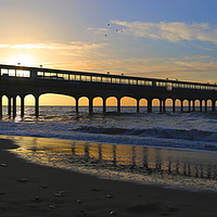Buy canvas prints of Coastal holiday perfect sunrise over pier with sea by Steve Mantell