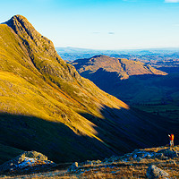 Buy canvas prints of Walker looking towards Pike o’Stickle by Jon Sparks