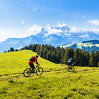 Buy canvas prints of Mountain bikers and Dents du Midi by Jon Sparks