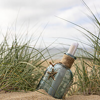 Buy canvas prints of Message in a bottle in the dunes by Anthony Hart