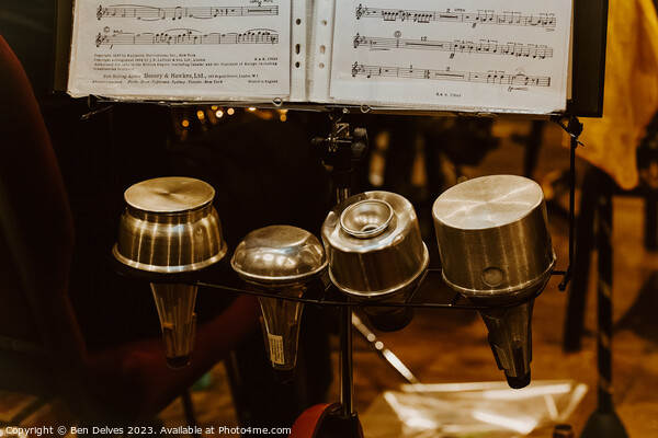 Trumpet mutes in a row with sheet music on a stand Picture Board by Ben Delves