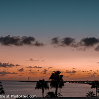 Buy canvas prints of A sunset view looking out to Faro de Punta Pechiguera by Ben Delves