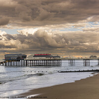 Buy canvas prints of Cromer Pier in the Evening Sun as a Storm rolled i by Heidi Hennessey