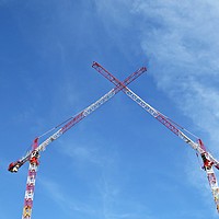 Buy canvas prints of Two White Red Construction Tower Cranes Crossing t by David Katrenčík
