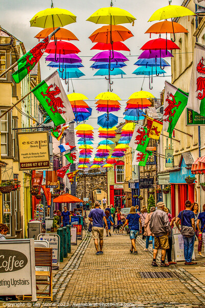 Umbrella Stroll in Caernarfon Picture Board by Ian Stone