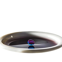 Buy canvas prints of Colourful water droplet balancing on cup of water by Rosaline Napier