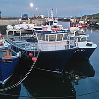 Buy canvas prints of Boats At Seahouses At night by Kevin Maughan