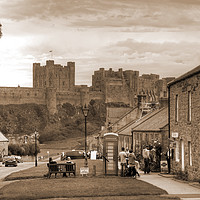 Buy canvas prints of Bamburgh Village and Castle - Sepia by Philip Brown
