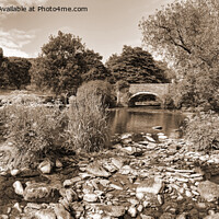 Buy canvas prints of Welsh stream leading to an old bridge by Philip Brown