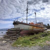 Buy canvas prints of Old Boat rusting on the Forshore, Beaumaris by Philip Brown