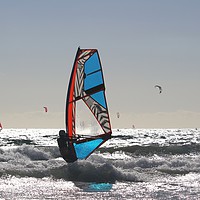 Buy canvas prints of Windsurfer among the shore break in back  light by Ines Porada