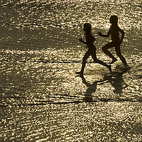 Buy canvas prints of two children run by the sea by Sergio Delle Vedove