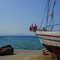 Buy canvas prints of Old Fishing Boat in Aegina Harbour by Cassi Moghan
