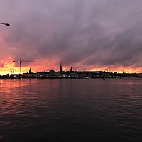 Buy canvas prints of Stormy Stockholm Sunset by Emma Corlett