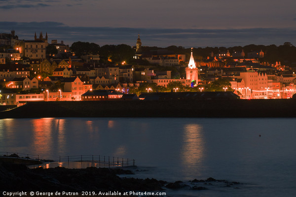 Night time over St Peter Port in Guernsey  Picture Board by George de Putron