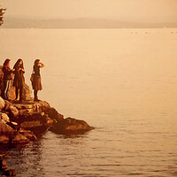 Buy canvas prints of Three girls at sunset on the sea border  by Luisa Vallon Fumi